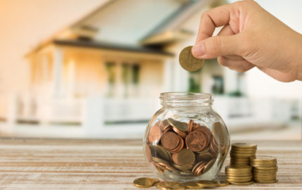 Person saving money up to purchase home