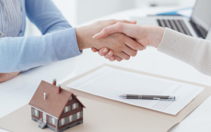 real estate and client shaking hands