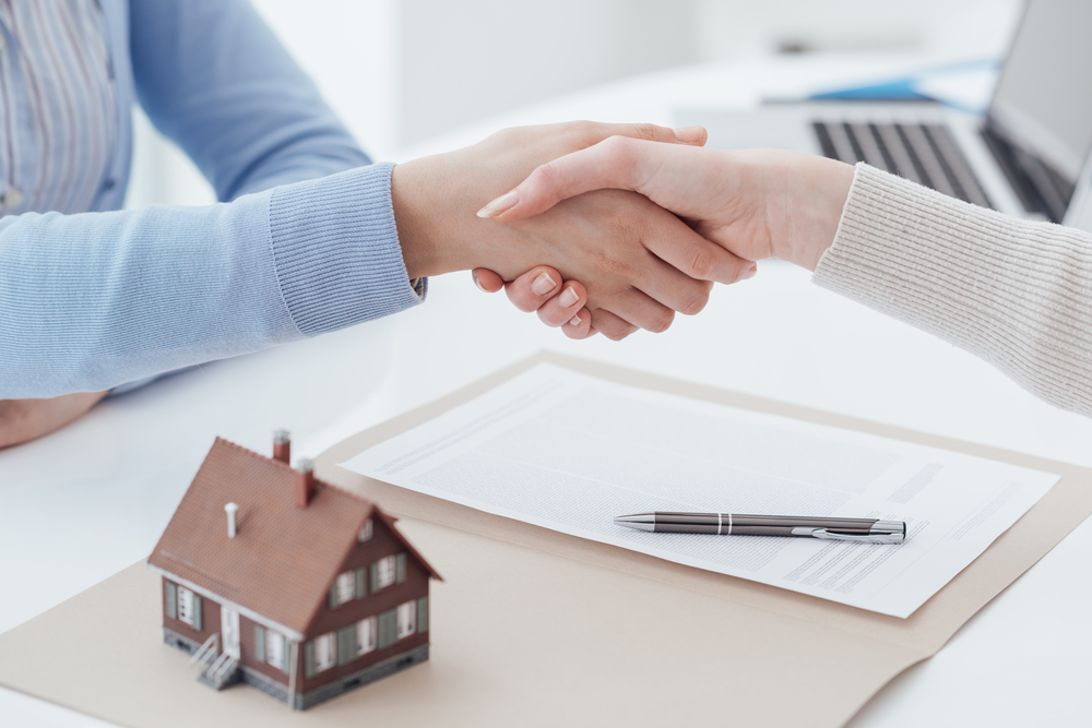 real estate and client shaking hands